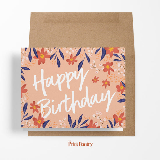 Floral Birthday Greeting Card laying on an open Kraft paper envelope 