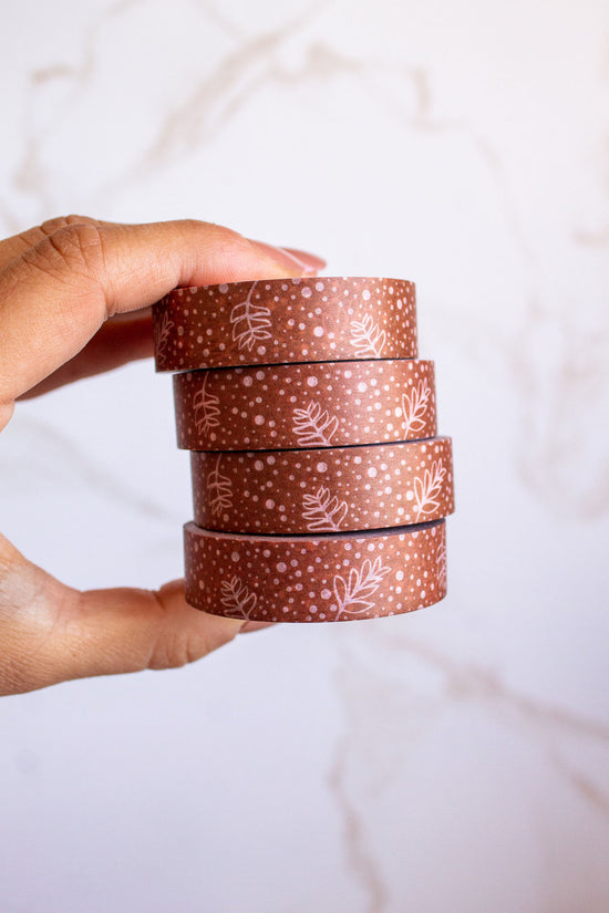 Woman holding a stack of Modern Floral Washi Tape