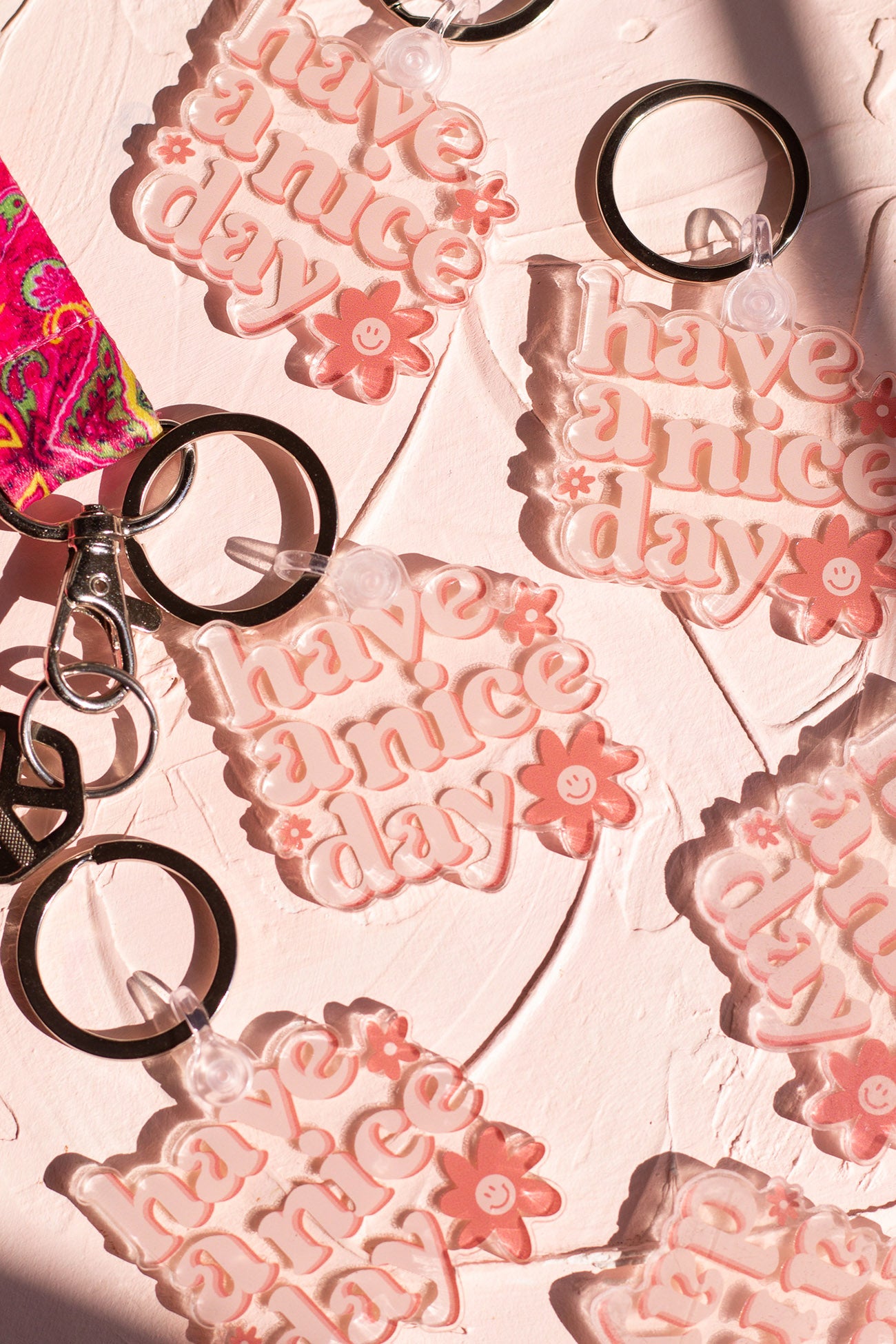 Have a Nice Day Keychains laying on a decorative background