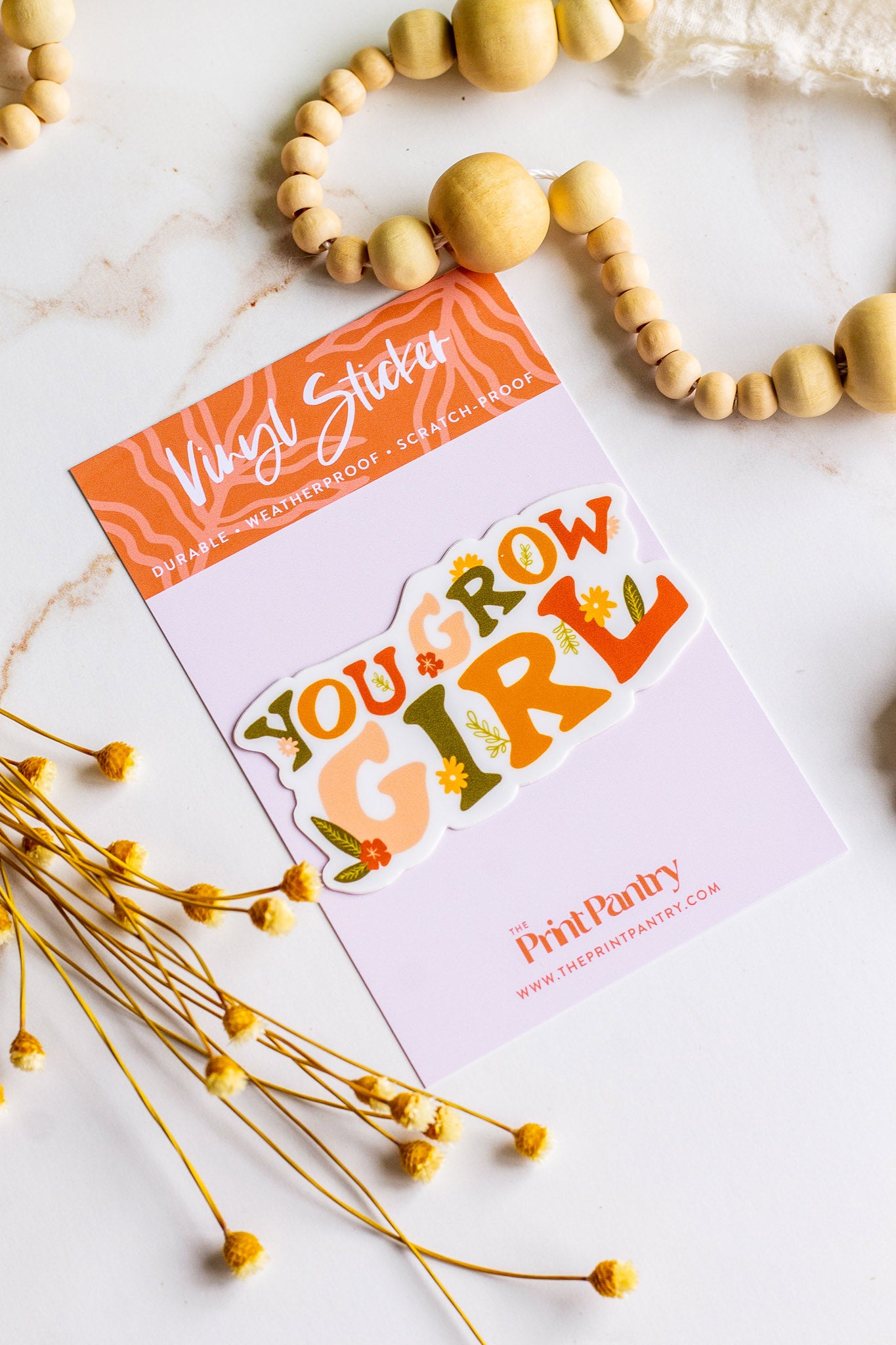 You Grow Girl Vinyl Sticker laying on it's informational sticker backing card