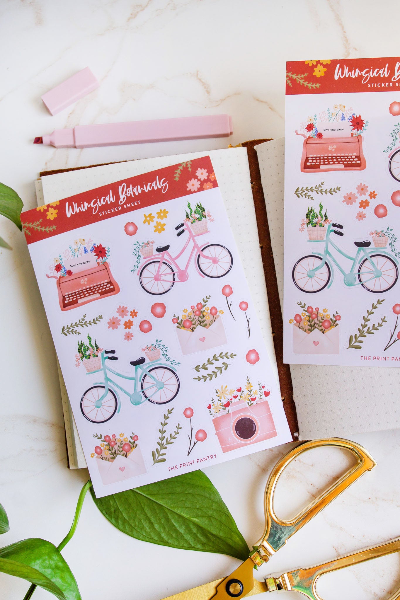 Whimsical Botanical Sticker Sheets laying on a decorative background