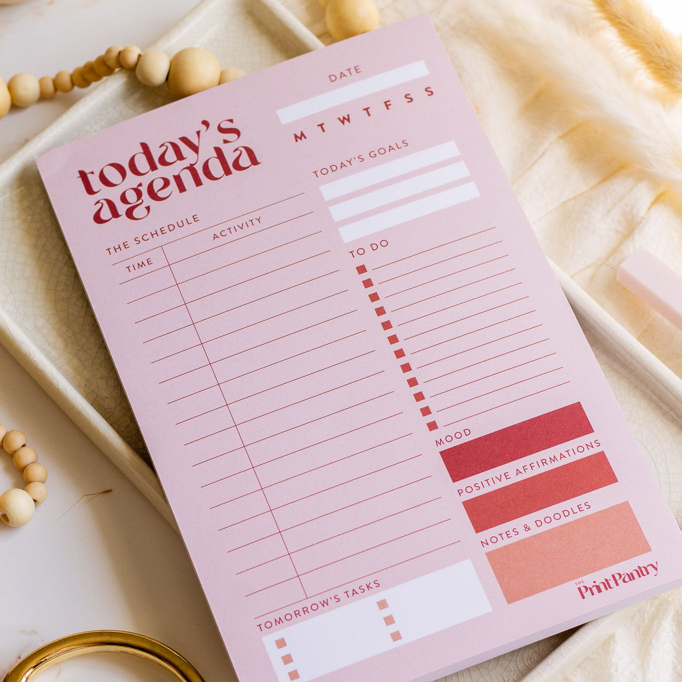 Daily Agenda Notepad laying on a decorative tray