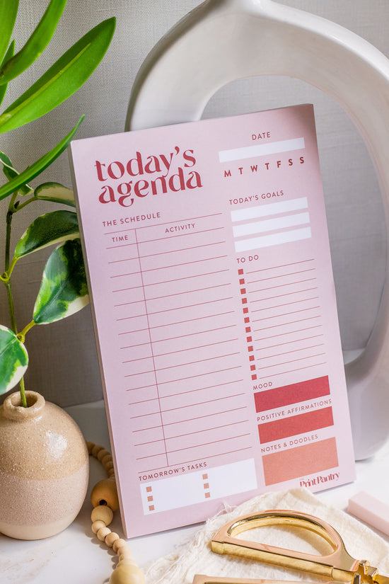Daily Agenda Notepad leaning against home decor