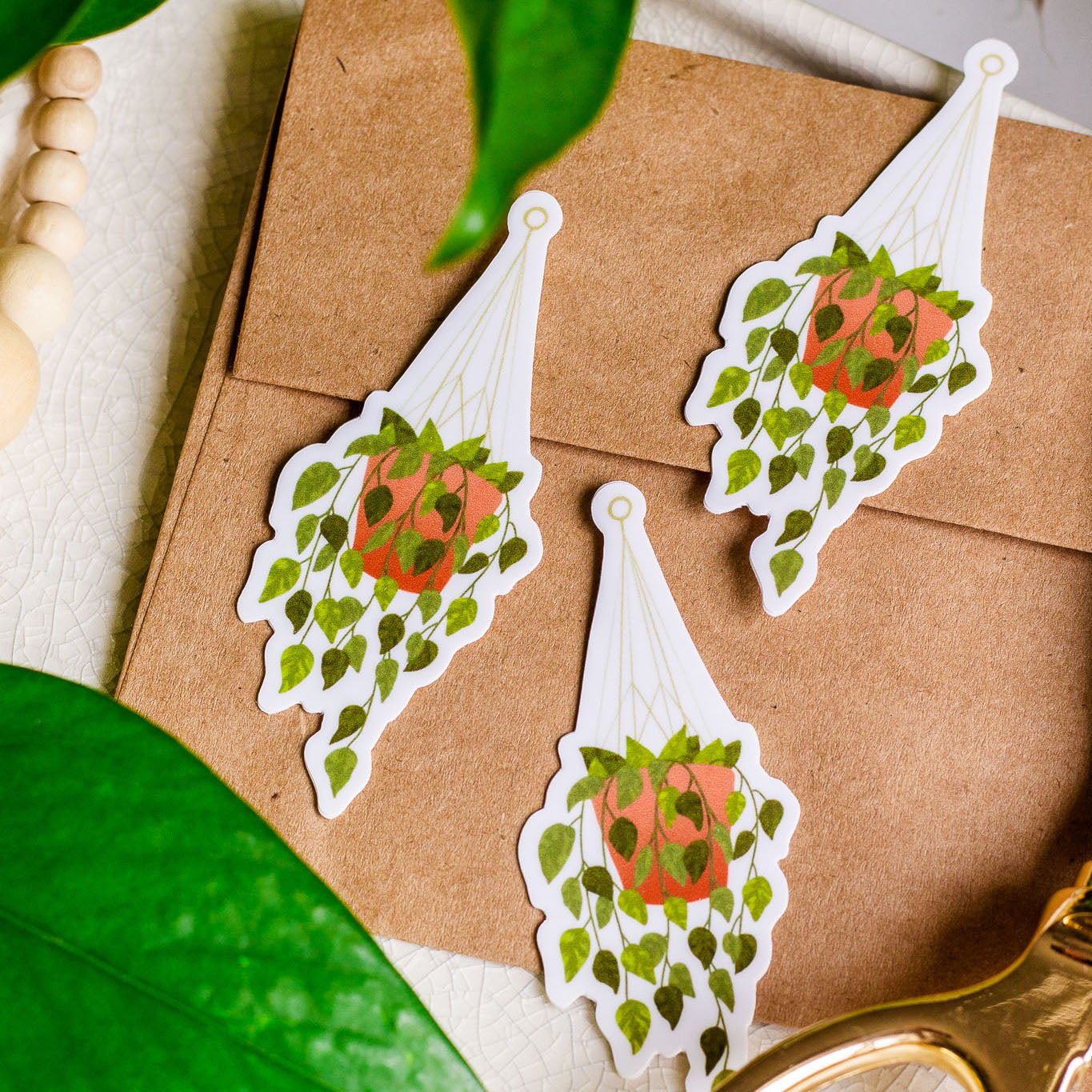 Hanging Plant Vinyl Stickers laying on a Kraft paper envelope