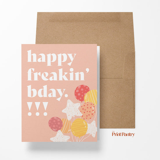 Happy Freakin' Birthday Greeting Card laying on an open Kraft paper envelope