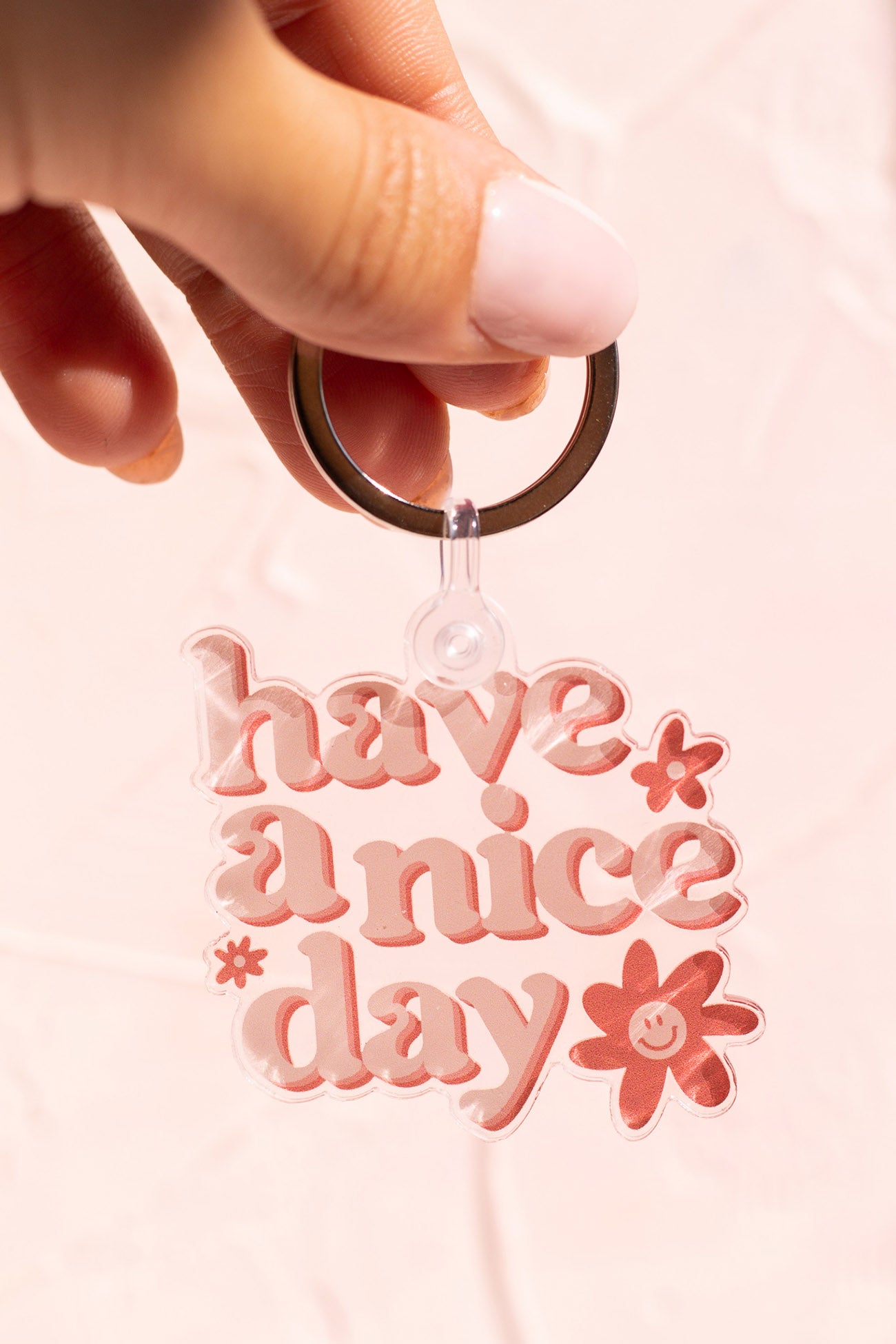 Woman holding a Have a Nice Day Keychain