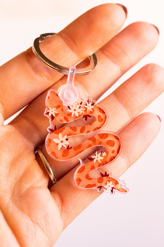 Woman holding a Floral Snake Keychain