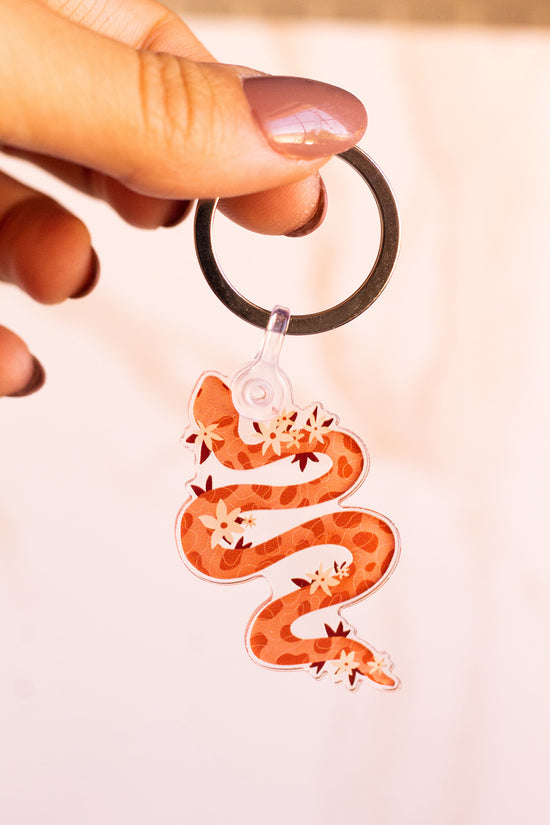 Load image into Gallery viewer, Woman holding a Floral Snake Keychain
